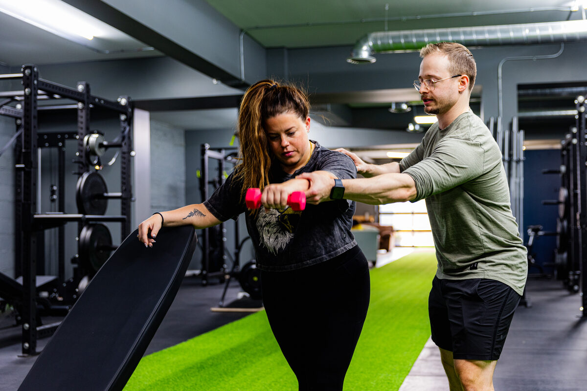 eFIT coach supporting a member during movement training